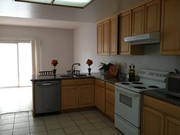 a kitchen with stainless steel appliances granite countertop a sink and cabinets