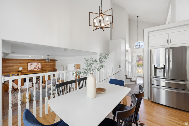 3732 Campbell Road Tooele, UT 84074 - Photo 22 of 69 Dining area featuring a white table and chairs, hardwood-finish flooring, and a contemporary chandelier