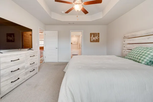 a bedroom with a large bed and a flat screen tv