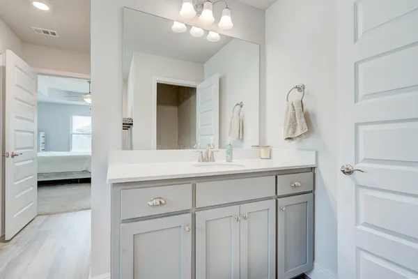 a bathroom with a double vanity sink and a mirror