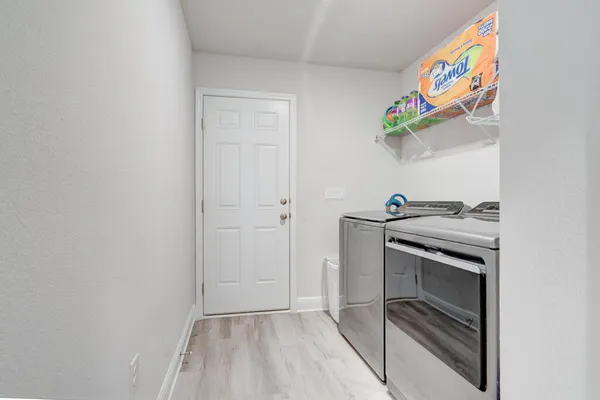 a bathroom with a sink a toilet a mirror and shower