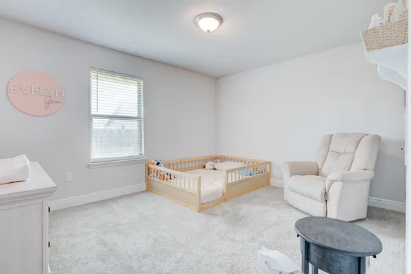 a white bed sitting in a white room
