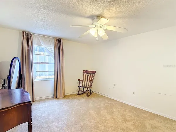 a view of a livingroom with a piano and wooden floor