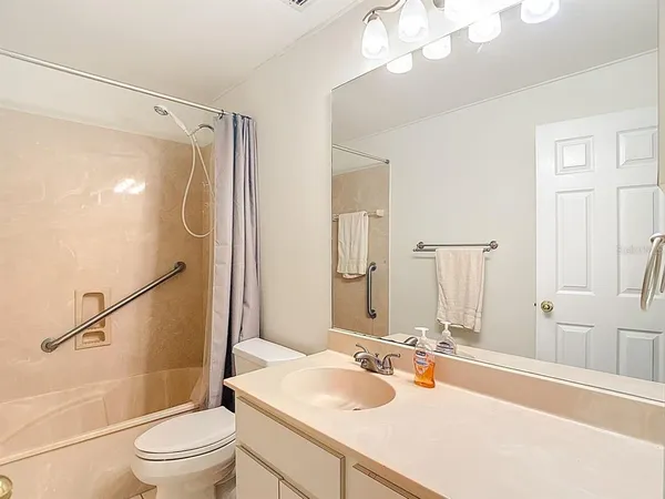 a bathroom with a sink a mirror and a shower