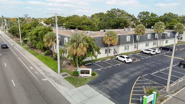 an aerial view of a house with garden space and street view