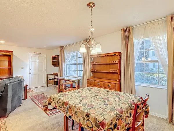 a bedroom with a bed a dresser and chair