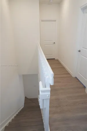 a view of entryway and hall with wooden floor