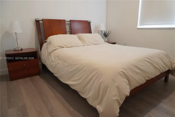 a bedroom with a bed and a lamp
