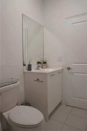a bathroom with a sink a toilet and mirror