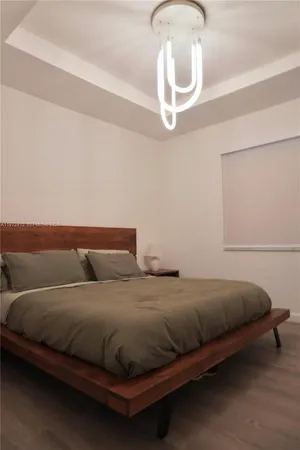 a bedroom with a bed and chandelier
