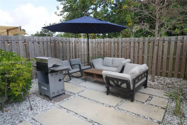 a backyard of a house with table and chairs