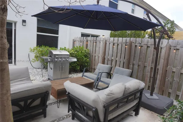 a view of an outdoor sitting area with furniture and umbrella