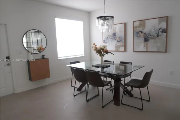 a view of a dining room with furniture and chandelier