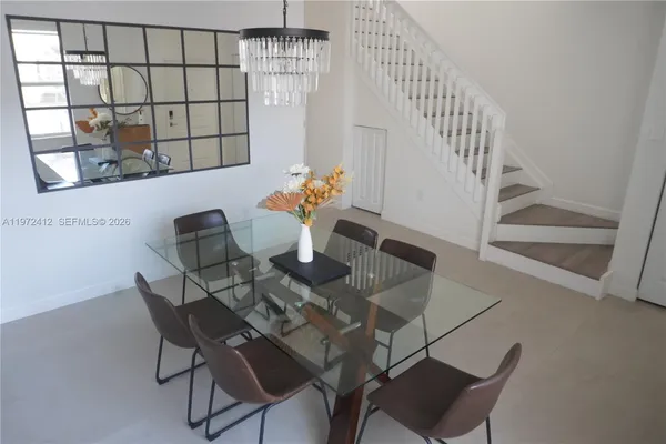 a view of a dining room with furniture and window