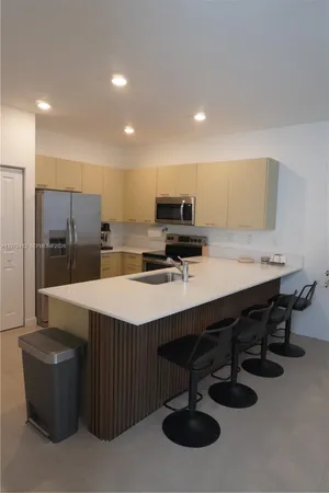 a kitchen with a sink stainless steel appliances and cabinets