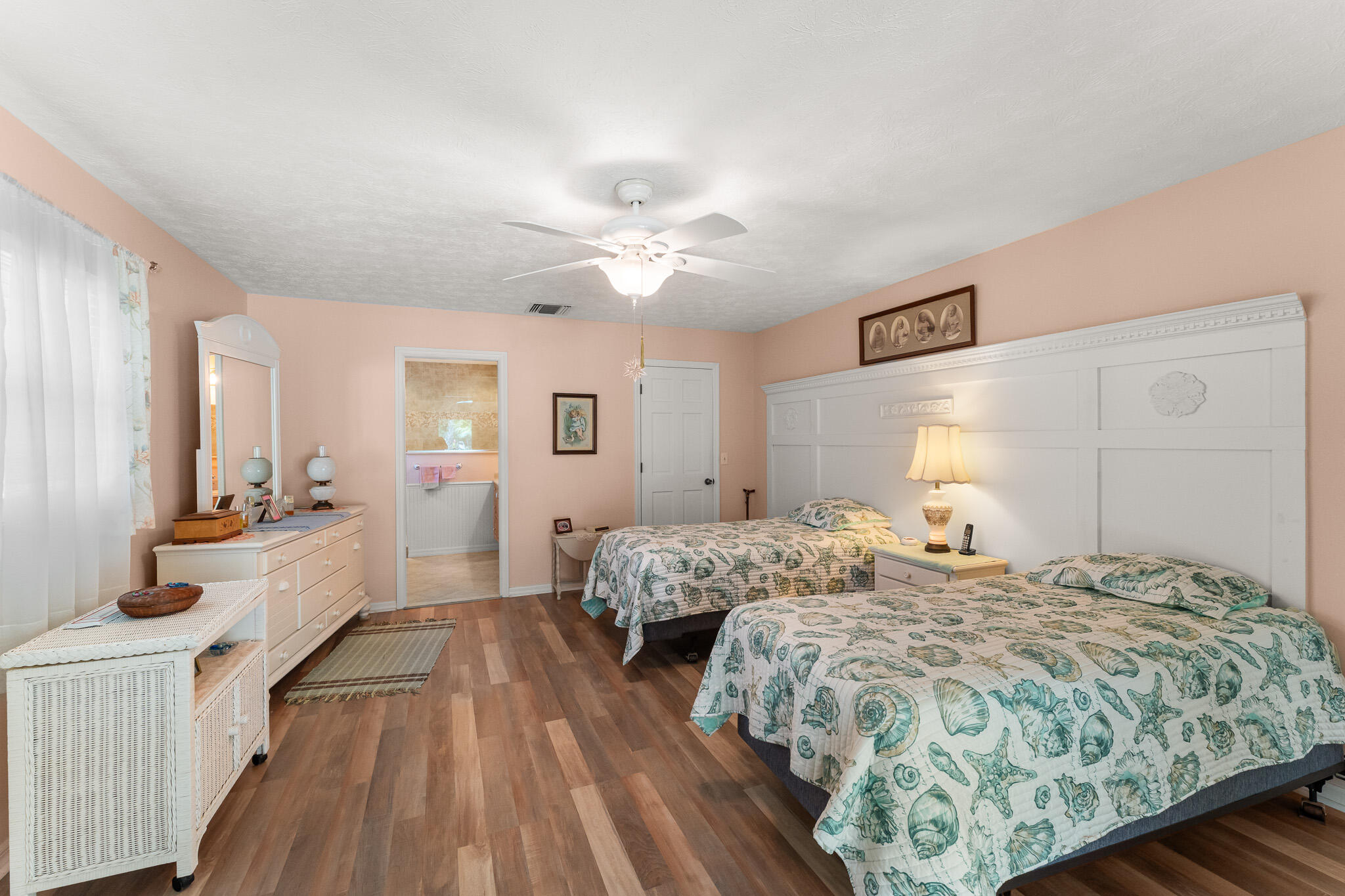 1653 Southwest 85th Terrace Stuart, FL 34997 - Photo 27 of 54 a spacious bedroom with a bed and wooden floor