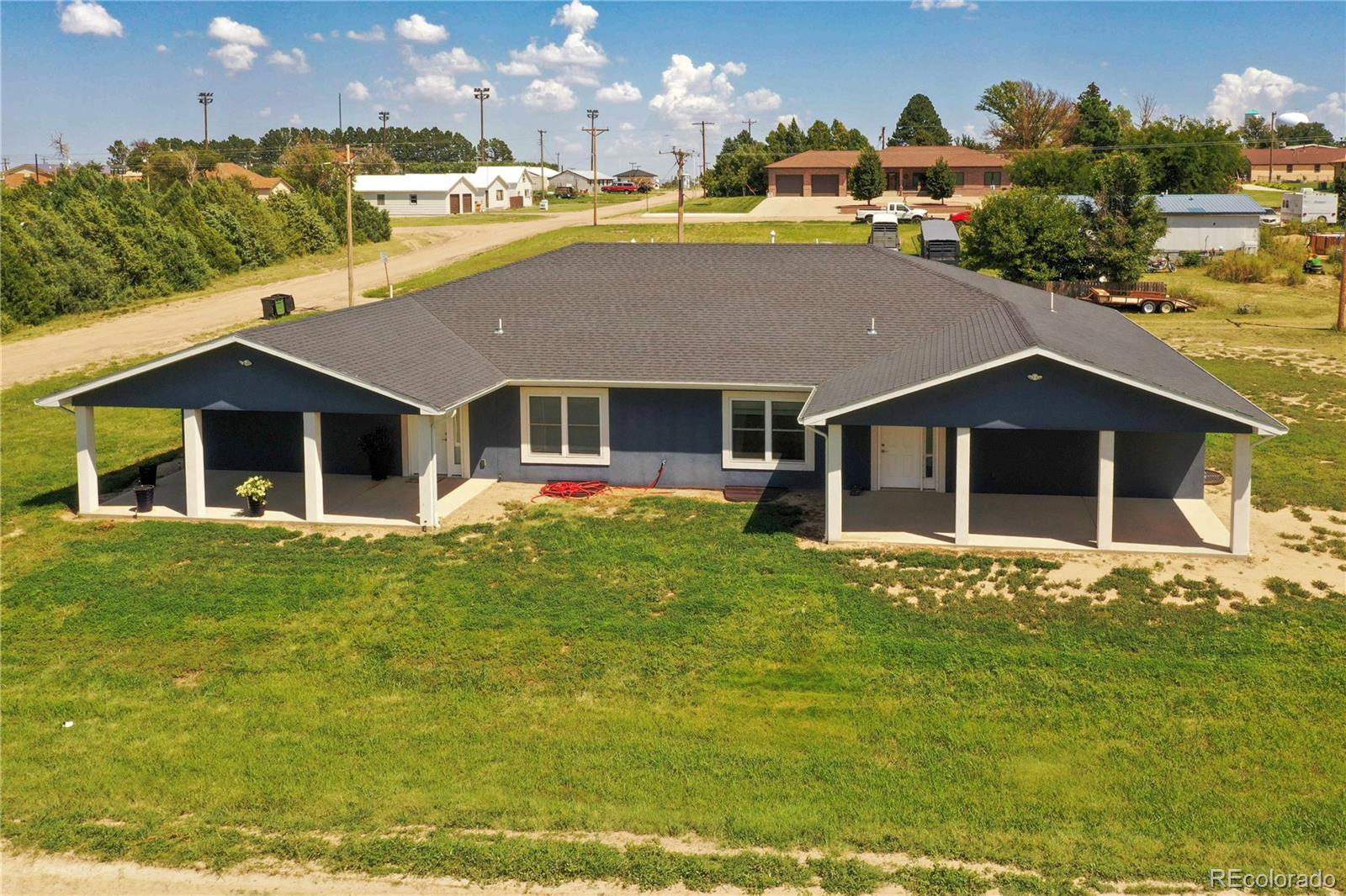 370 West 8th Street North, Unit A & B Cheyenne Wells, CO 80810 - Photo 1 of 47 a front view of a house with a yard
