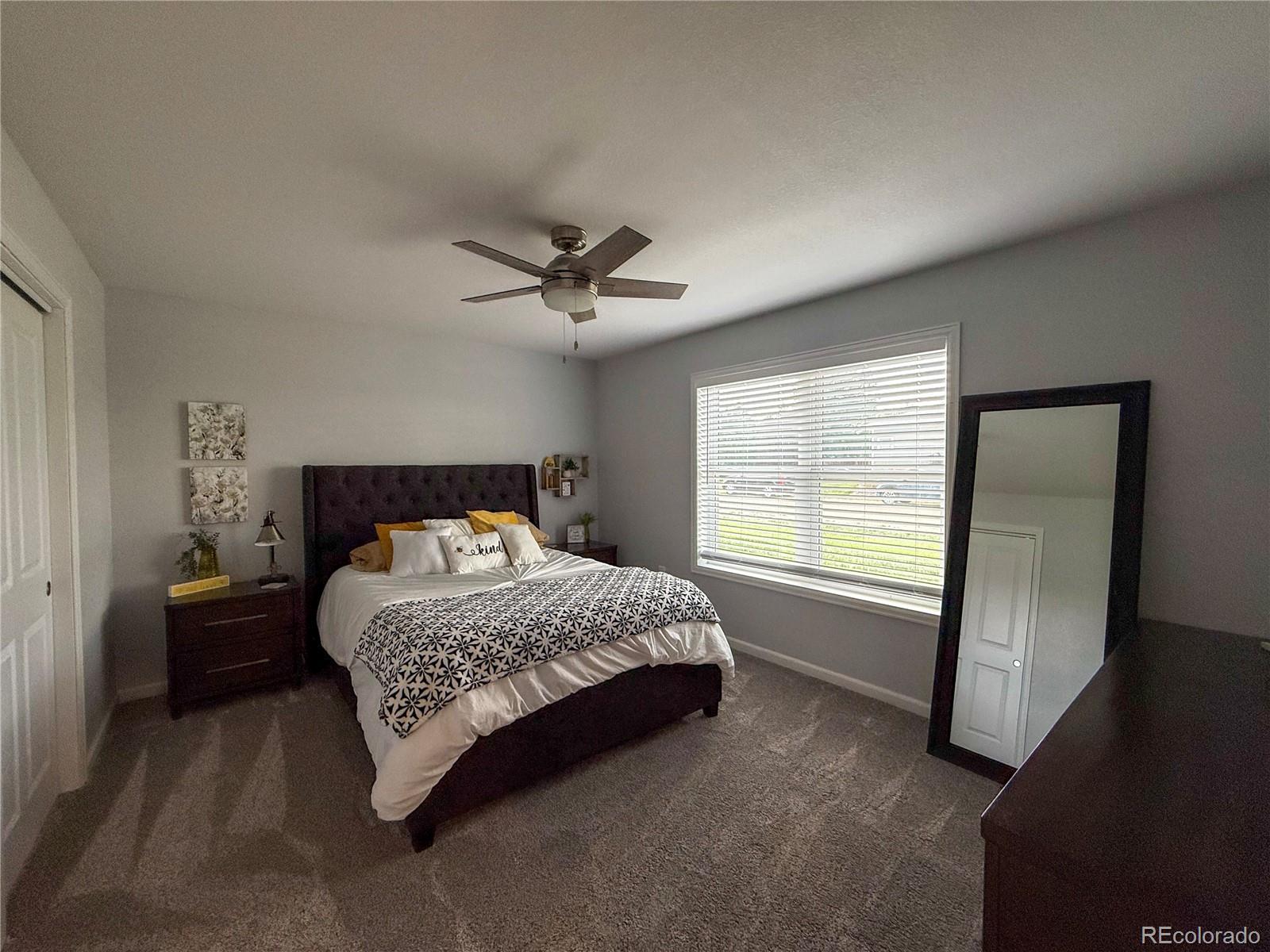 370 West 8th Street North, Unit A & B Cheyenne Wells, CO 80810 - Photo 12 of 47 a bedroom with a bed a chandelier and a window