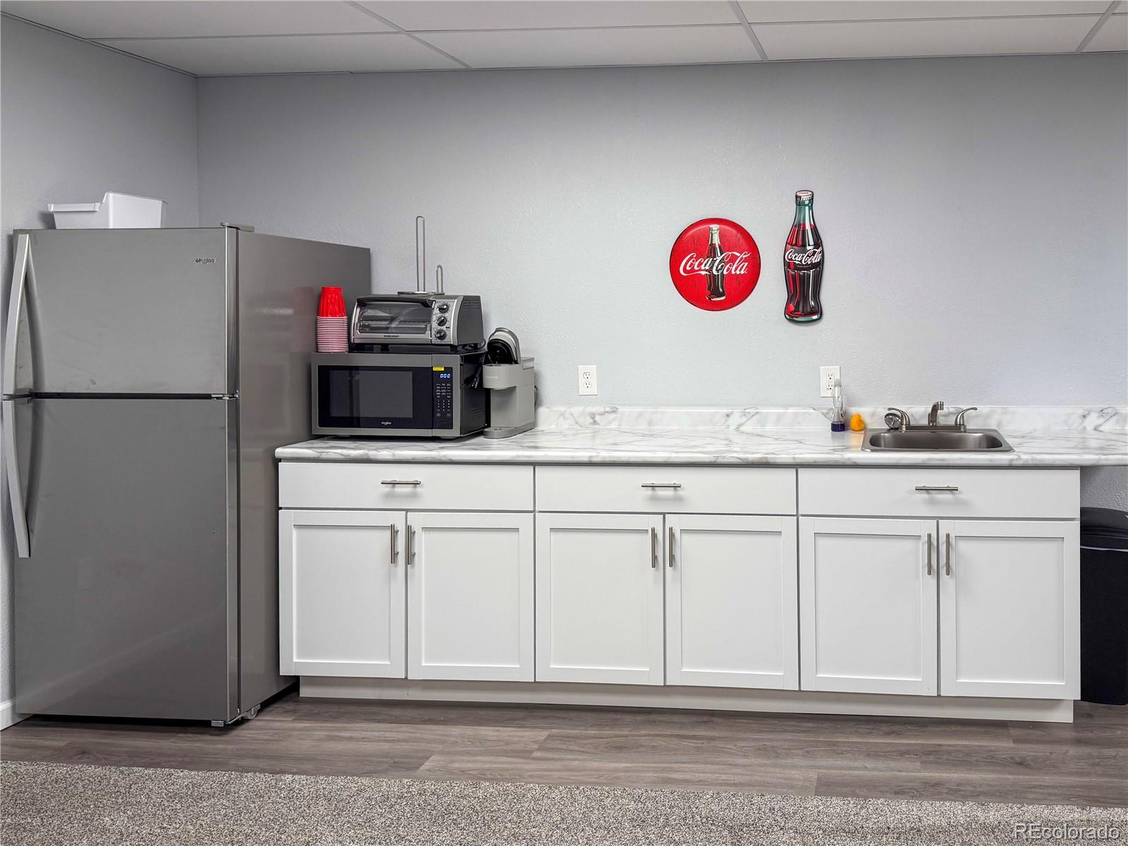 370 West 8th Street North, Unit A & B Cheyenne Wells, CO 80810 - Photo 17 of 47 a kitchen with cabinets and white appliances