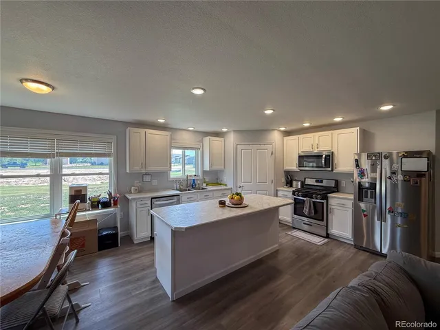 a view of kitchen with sink microwave and stove