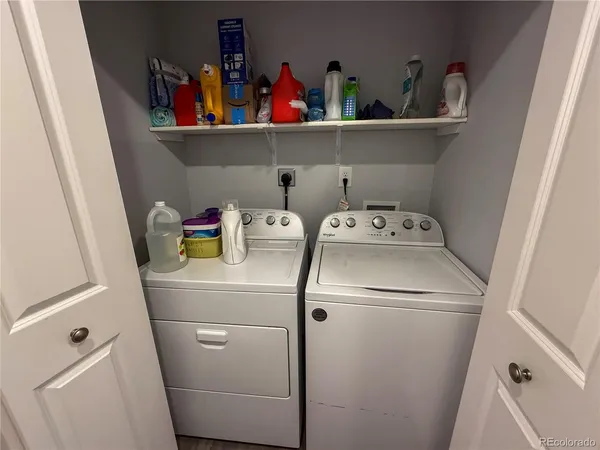 a bathroom with a granite countertop sink a toilet a mirror and shower