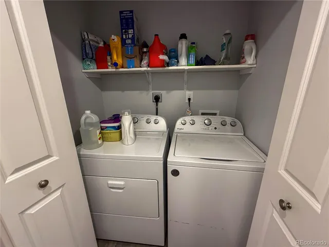 a bathroom with a granite countertop sink a toilet a mirror and shower