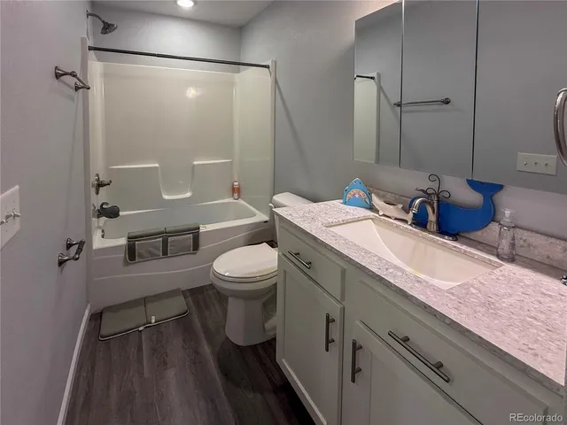 a living room with furniture and a rug