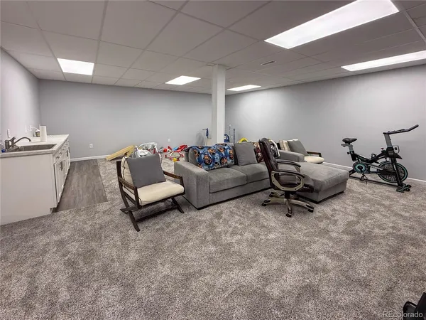 a kitchen with white cabinets and sink