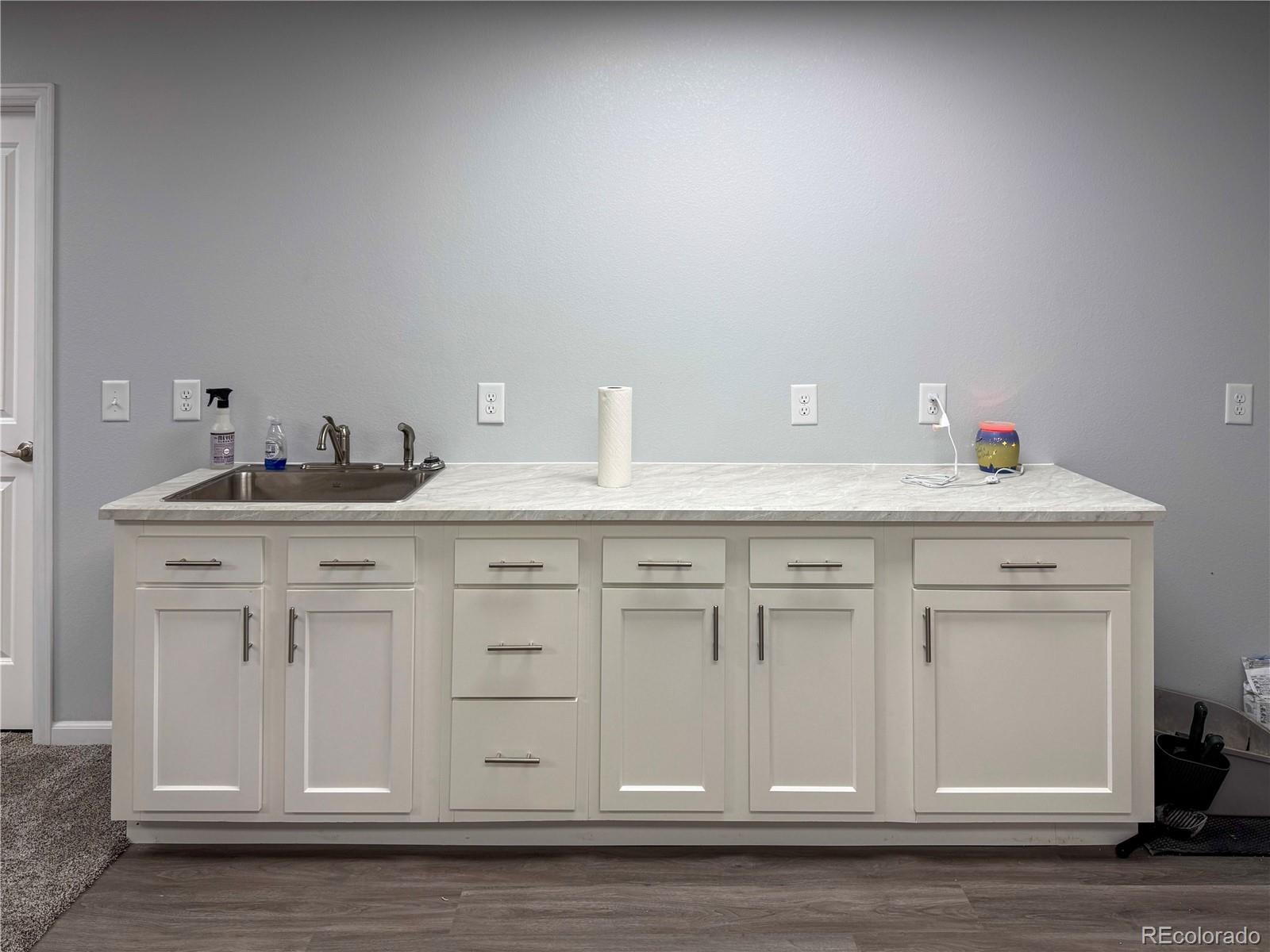 370 West 8th Street North, Unit A & B Cheyenne Wells, CO 80810 - Photo 39 of 47 a kitchen with white cabinets and sink