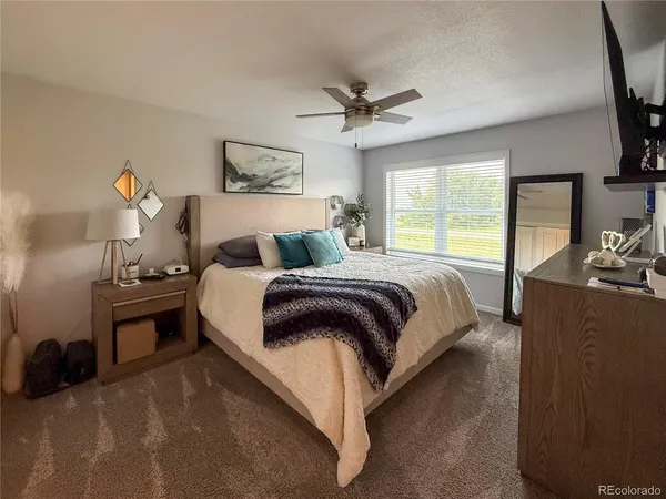 a bedroom with a bed and a couch