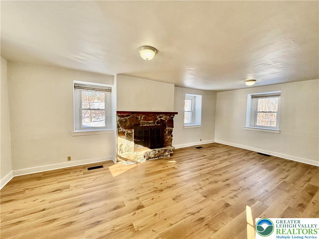 171 East Aluta Mill Road Nazareth, PA 18064 - Photo 5 of 11 a view of empty room with wooden floor and fireplace