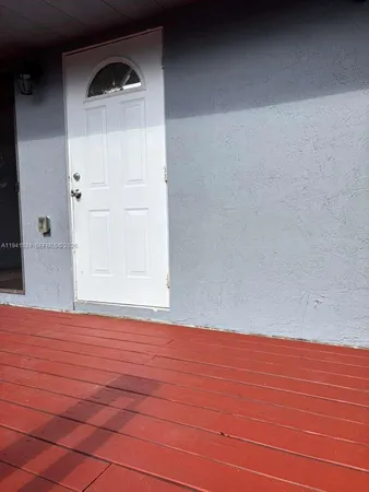 a view of wooden floor and windows in a room