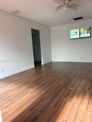 a view of a kitchen with a sink and wooden floor