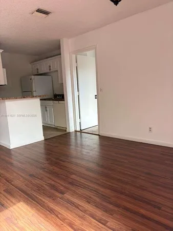 a view of a kitchen with a sink and a window