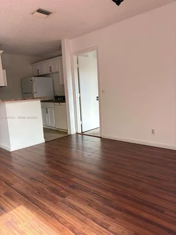 a view of a kitchen with a sink and a window