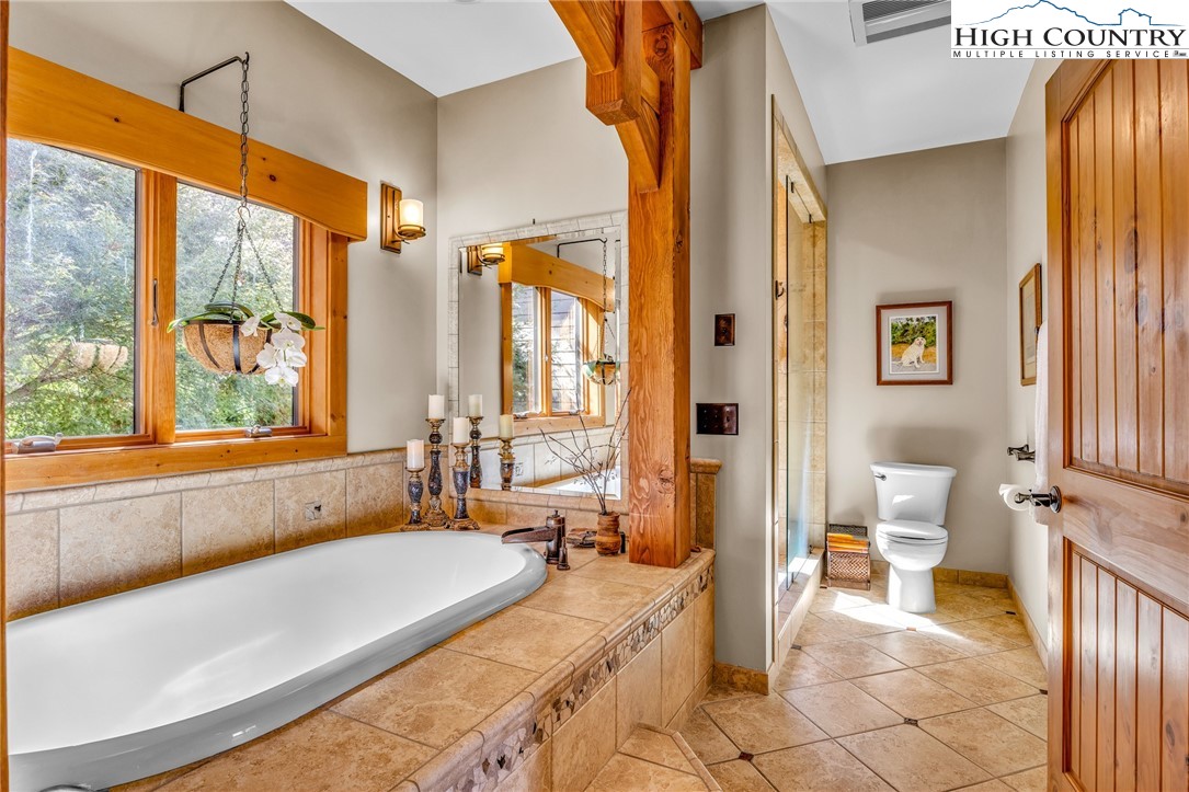 2650 Carson Woods Road Laurel Springs, NC 28644 - Photo 19 of 50 a spacious bathroom with a tub and a large window