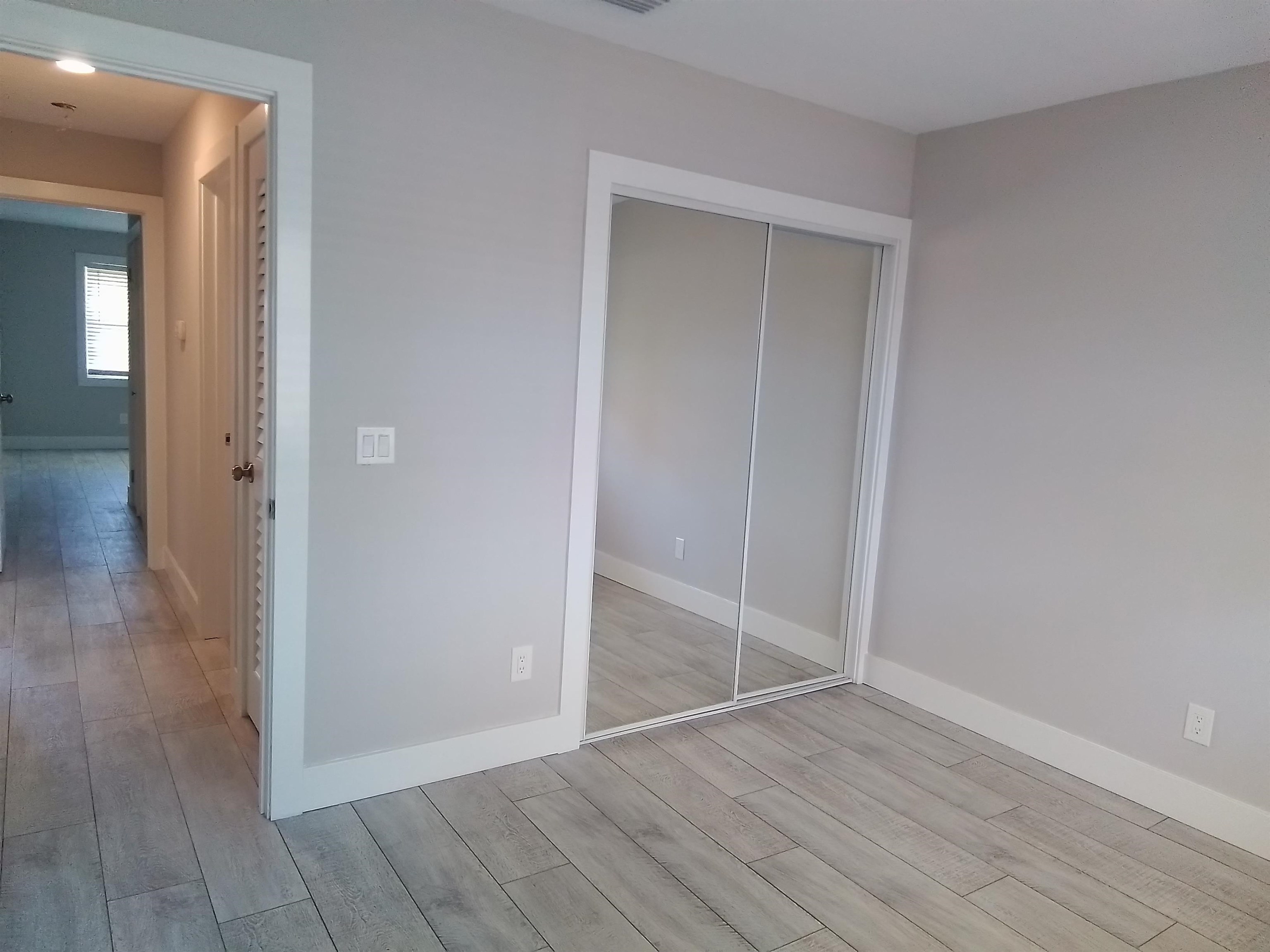 650 West Pope Road, Unit 244 St. Augustine, FL 32080 - Photo 17 of 27 an empty room with wooden floor & closet area
