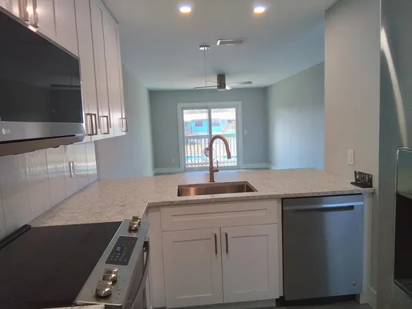 a kitchen with a sink stove and microwave