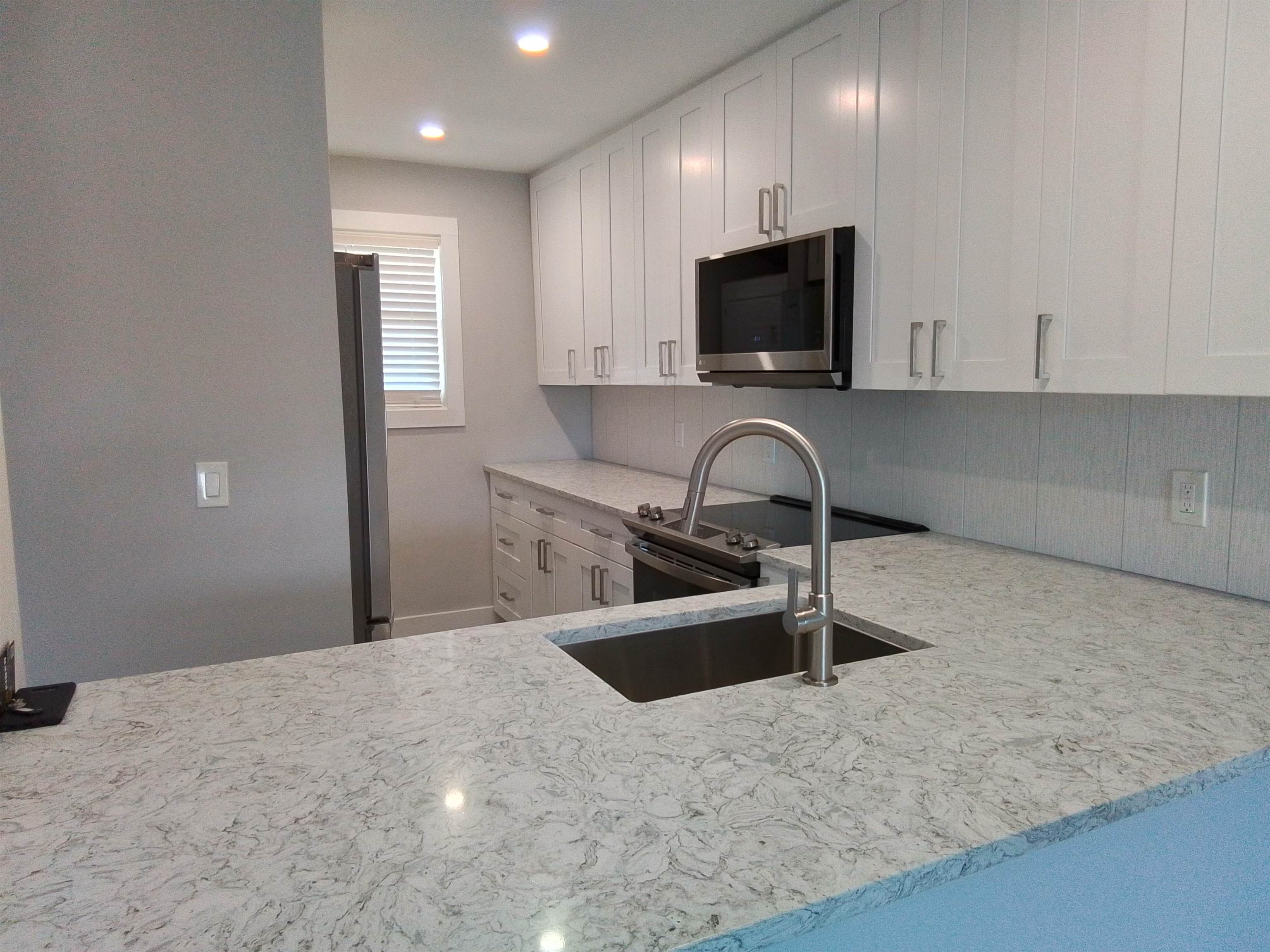 650 West Pope Road, Unit 244 St. Augustine, FL 32080 - Photo 6 of 27 a kitchen with stainless steel appliances a sink a stove a microwave a sink and a refrigerator