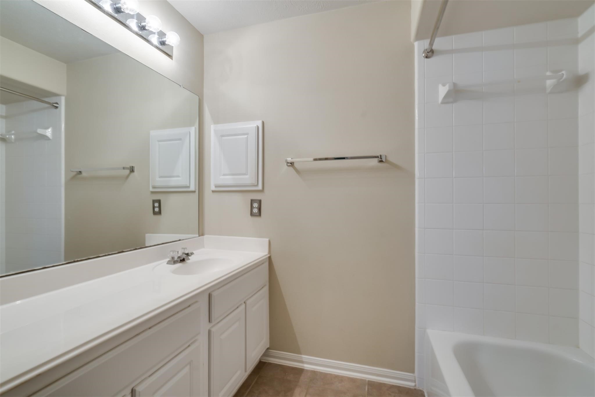 3419 La Fleur Lane Spring, TX 77388 - Photo 21 of 26 a bathroom with a sink a mirror and a bathtub