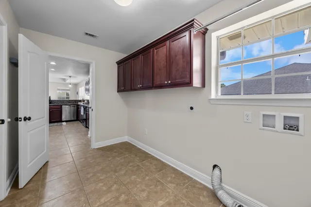 a spacious bedroom with a bed a couch and dresser