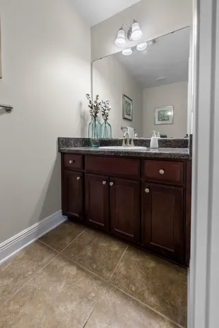 a spacious bedroom with a bed a couch and a flat screen tv