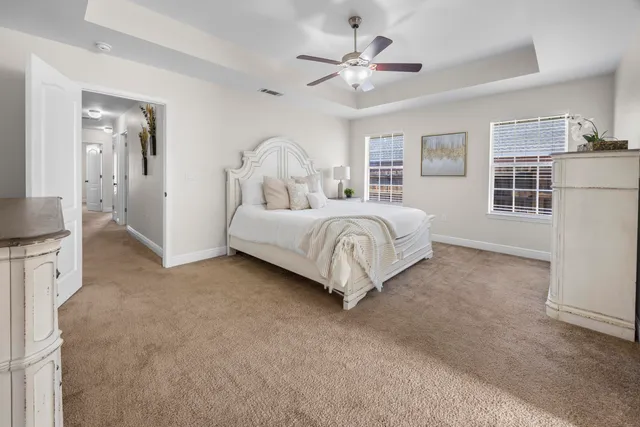 an empty room with a window and a ceiling fan