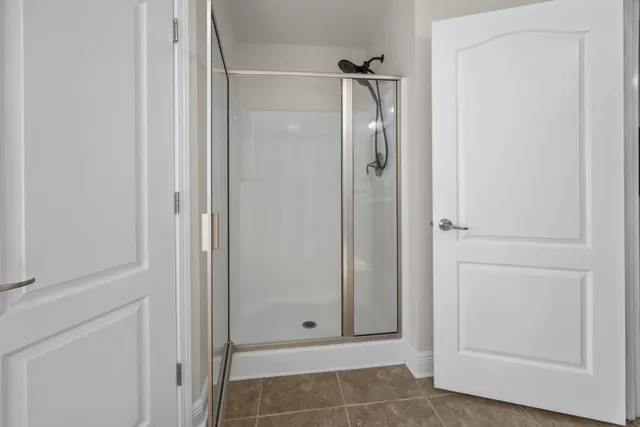a bathroom with a granite countertop sink a toilet a mirror and shower