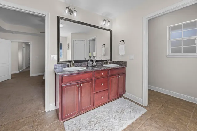 a spacious bedroom with a bed and a ceiling fan