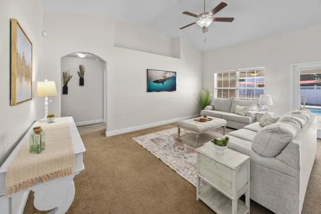 a living room with furniture and a chandelier