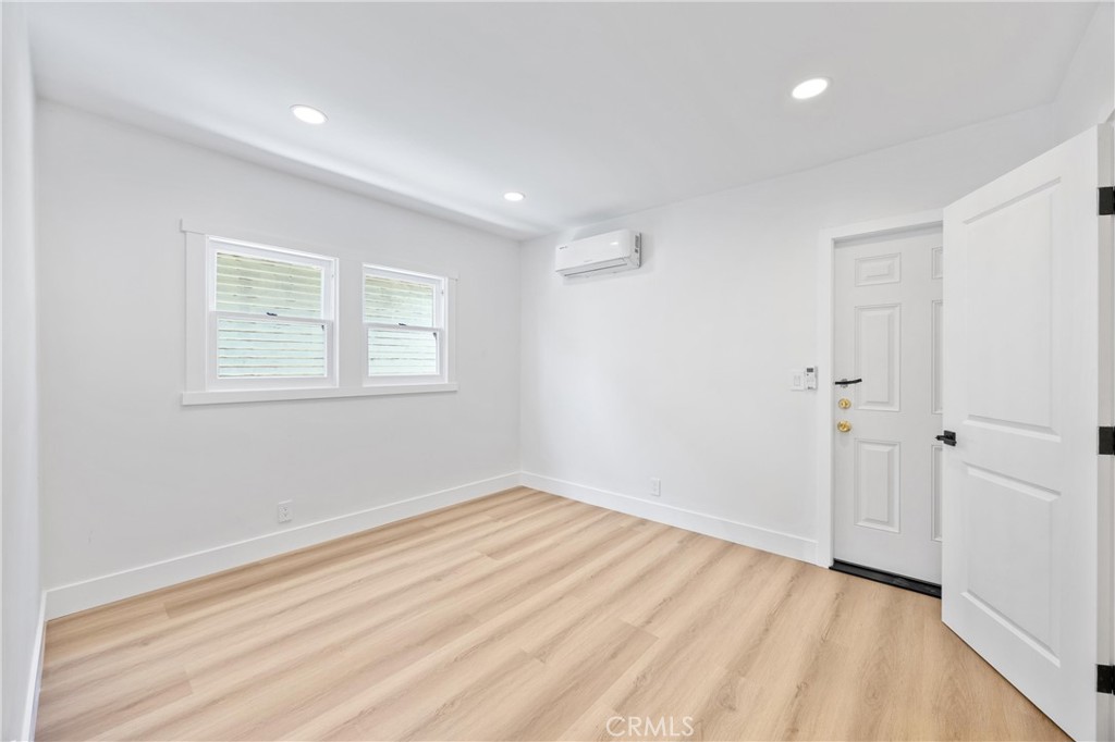 852 Orange Avenue Long Beach, CA 90813 - Photo 17 of 39 a view of an empty room with wooden floor and a window