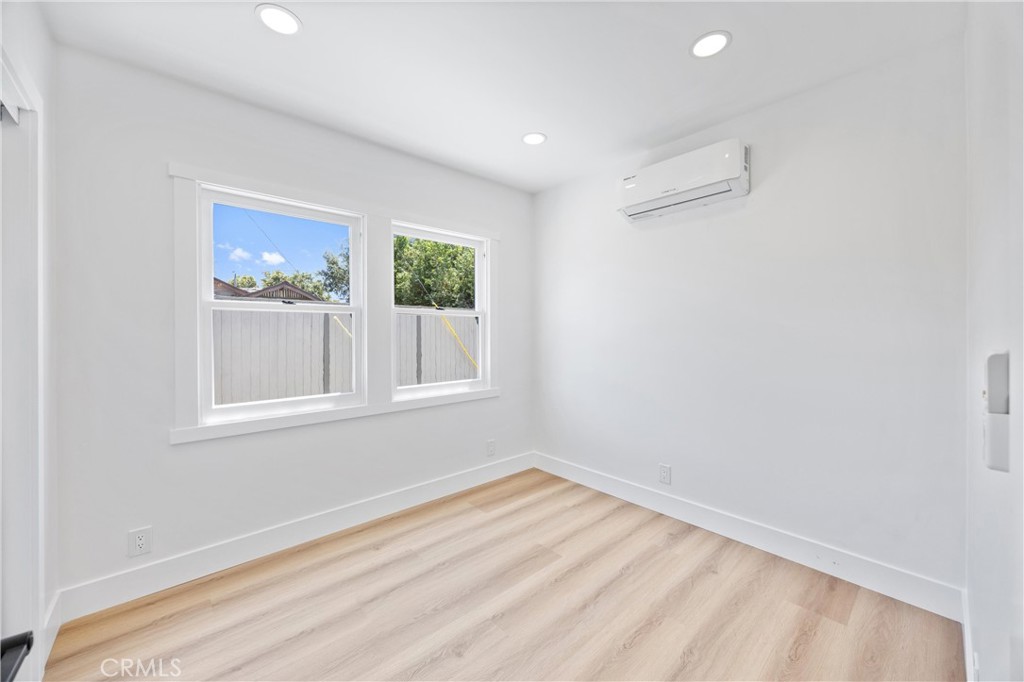 852 Orange Avenue Long Beach, CA 90813 - Photo 31 of 39 a view of empty room with window and wooden floor