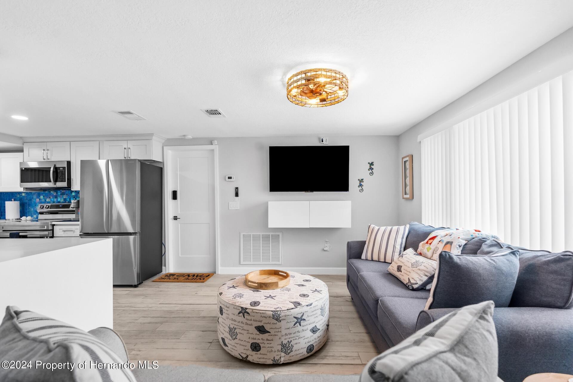 12535 3rd Isle Hudson, FL 34667 - Photo 12 of 46 a living room with furniture and a flat screen tv