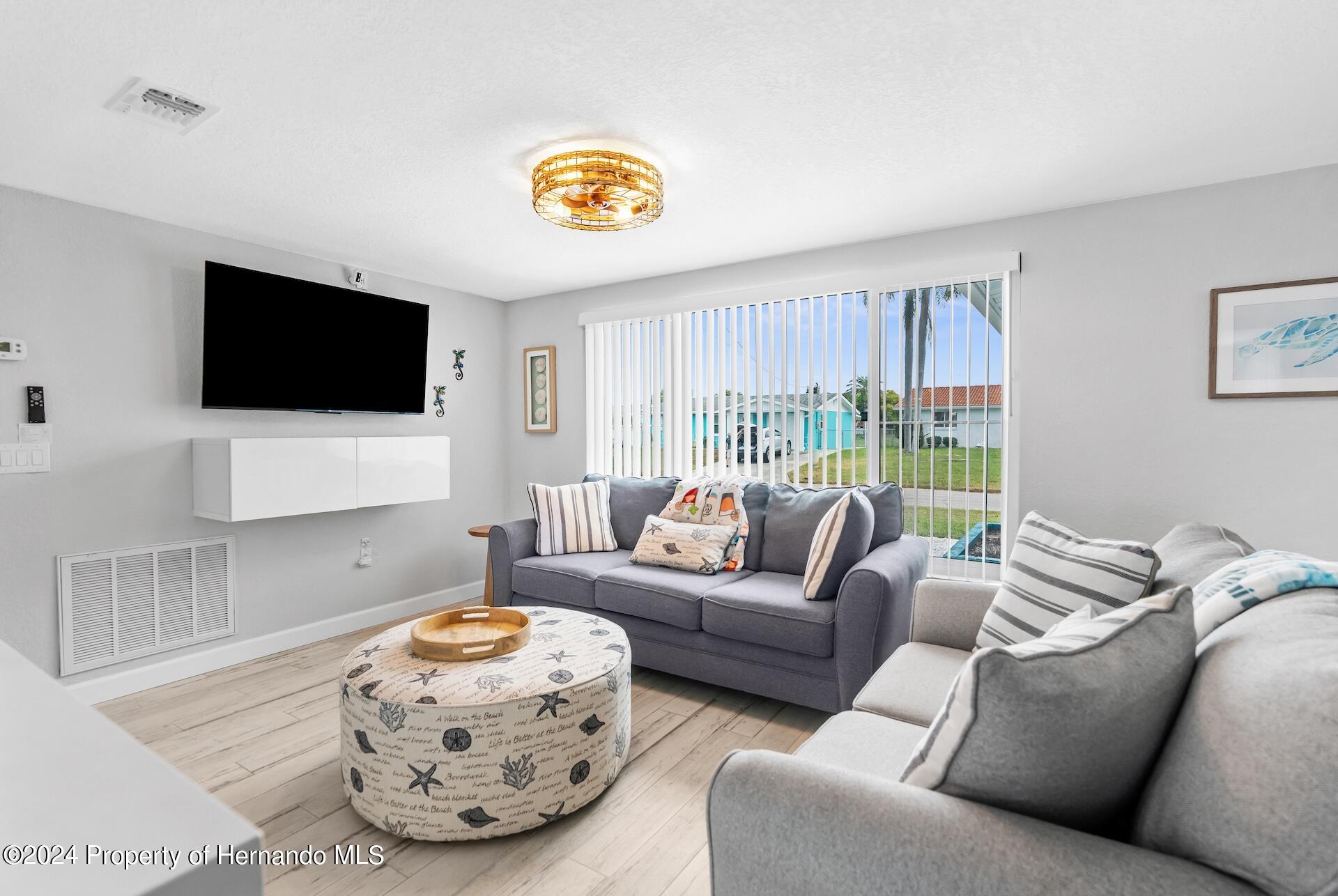 12535 3rd Isle Hudson, FL 34667 - Photo 13 of 46 a living room with furniture and a flat screen tv